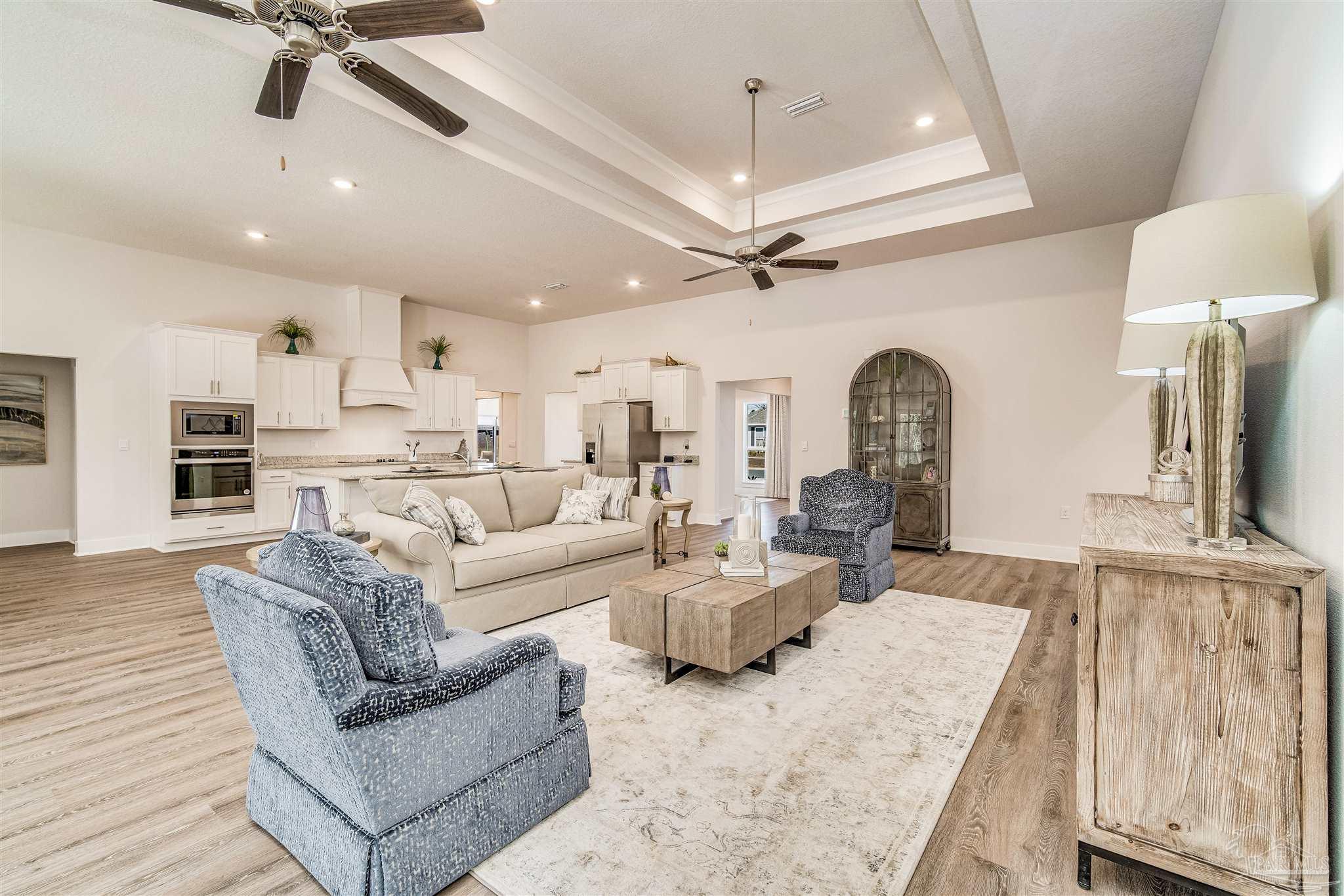 5780 Windham Road Milton, FL 32570 - Photo 13 of 37 a living room with furniture and a chandelier