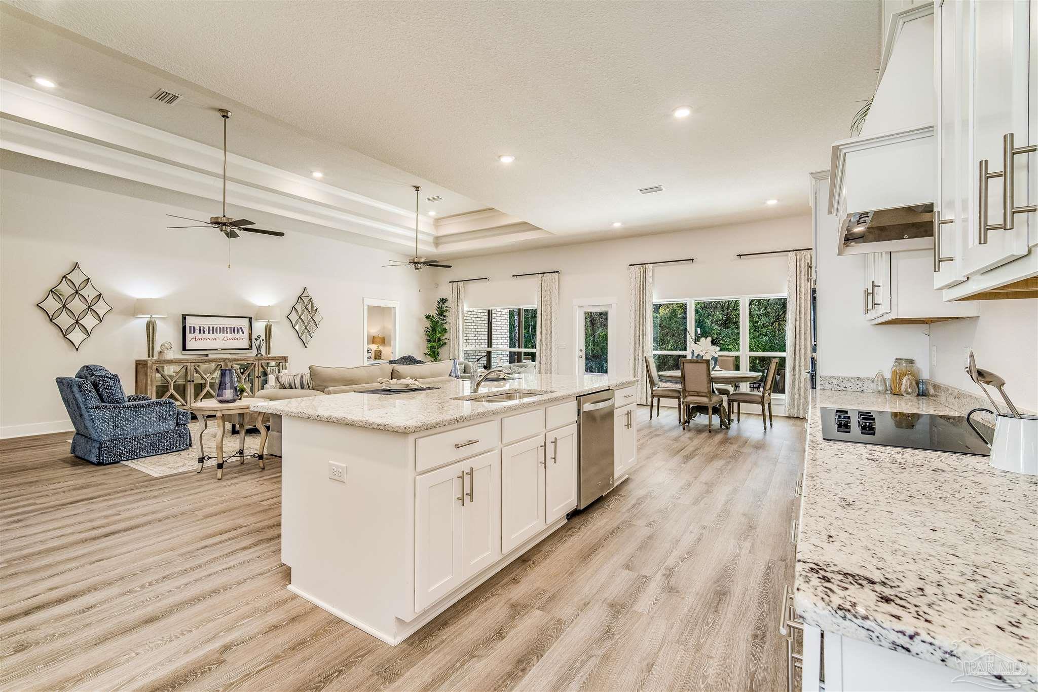 5780 Windham Road Milton, FL 32570 - Photo 16 of 37 a large kitchen with stainless steel appliances granite countertop a lot of counter space and wooden floors