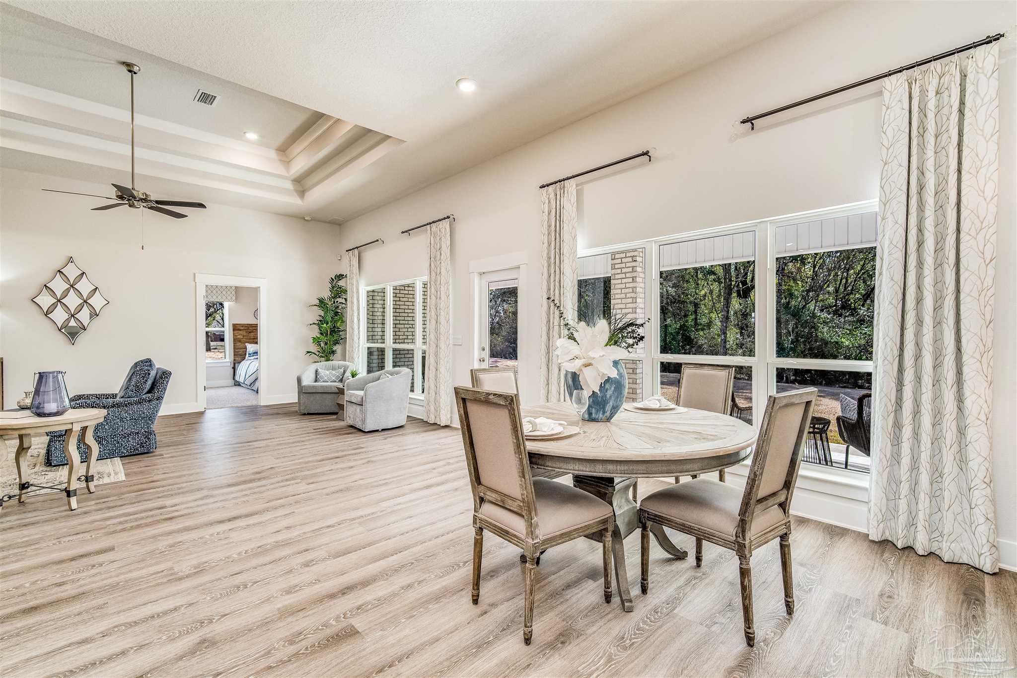 5780 Windham Road Milton, FL 32570 - Photo 18 of 37 a view of a dining room with furniture window and wooden floor