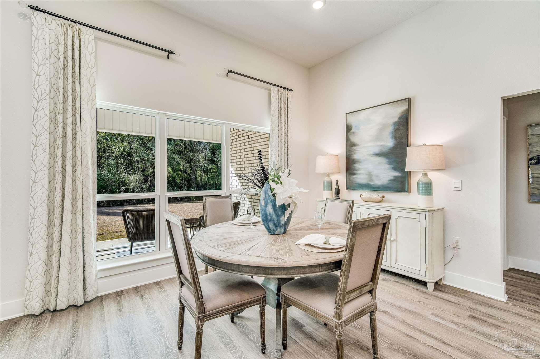 5780 Windham Road Milton, FL 32570 - Photo 20 of 37 a view of a dining room with furniture window and wooden floor