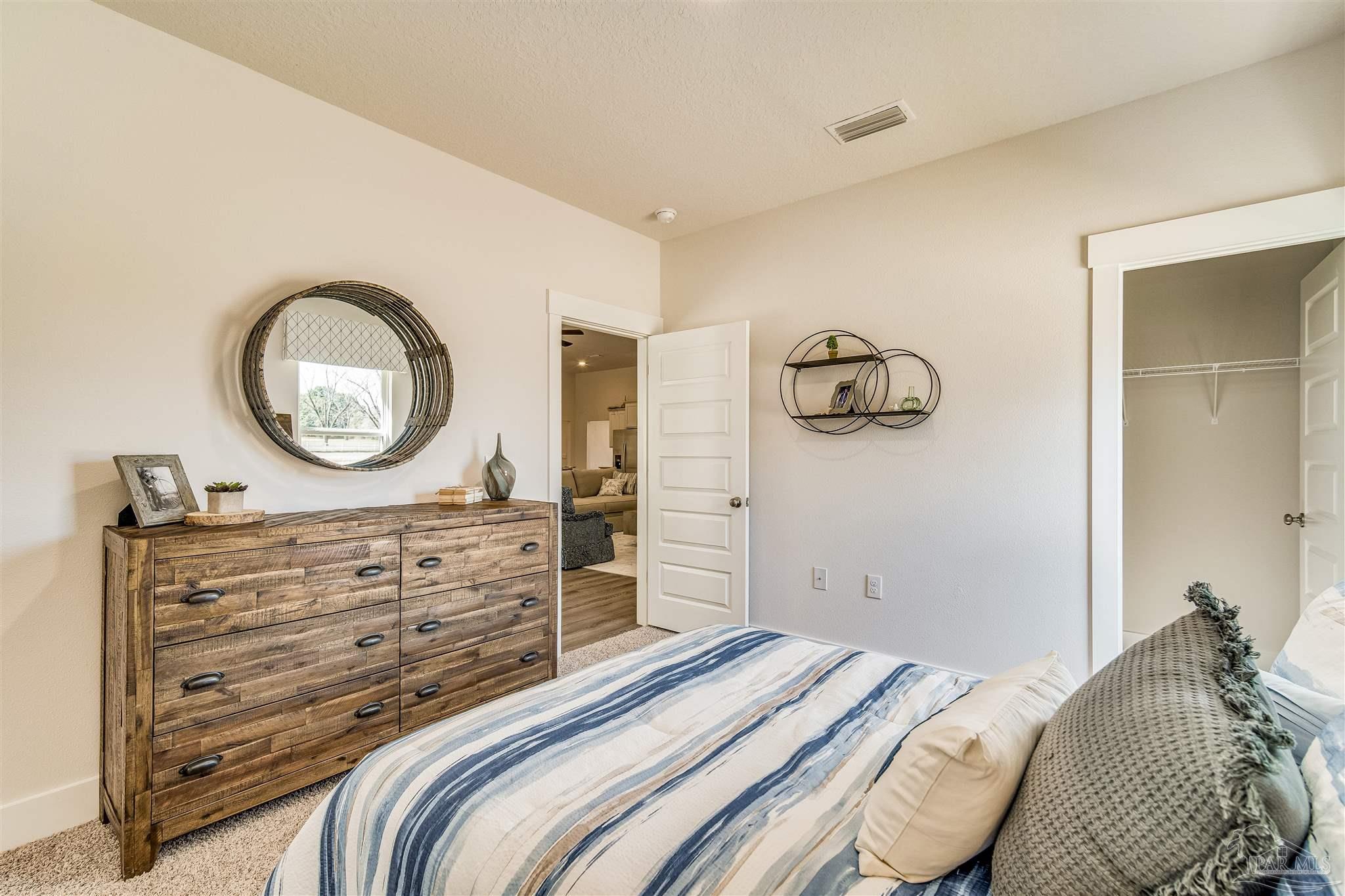 5780 Windham Road Milton, FL 32570 - Photo 22 of 37 a bedroom with a bed and a dresser