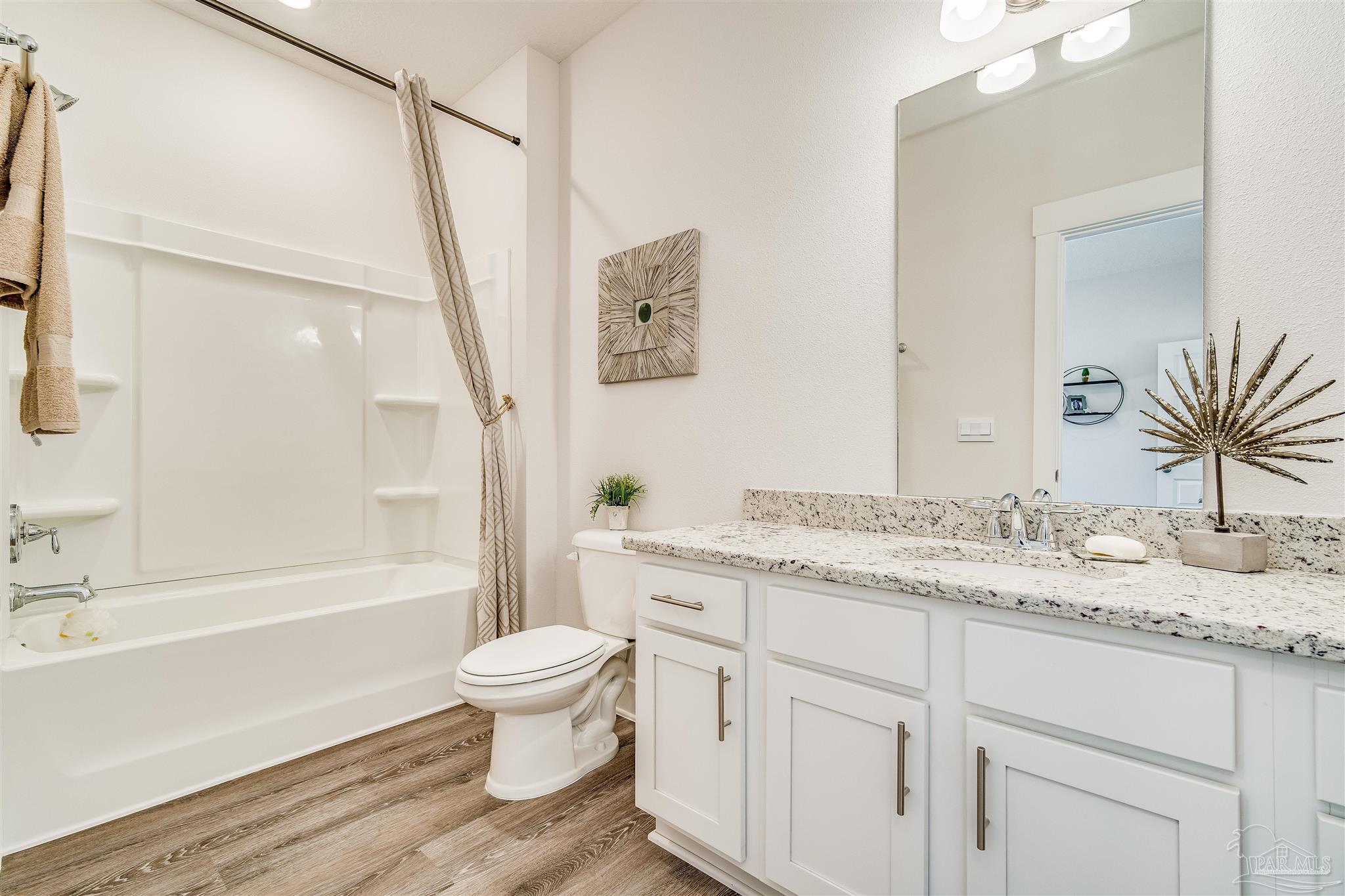 5780 Windham Road Milton, FL 32570 - Photo 23 of 37 a bathroom with a granite countertop sink toilet and shower