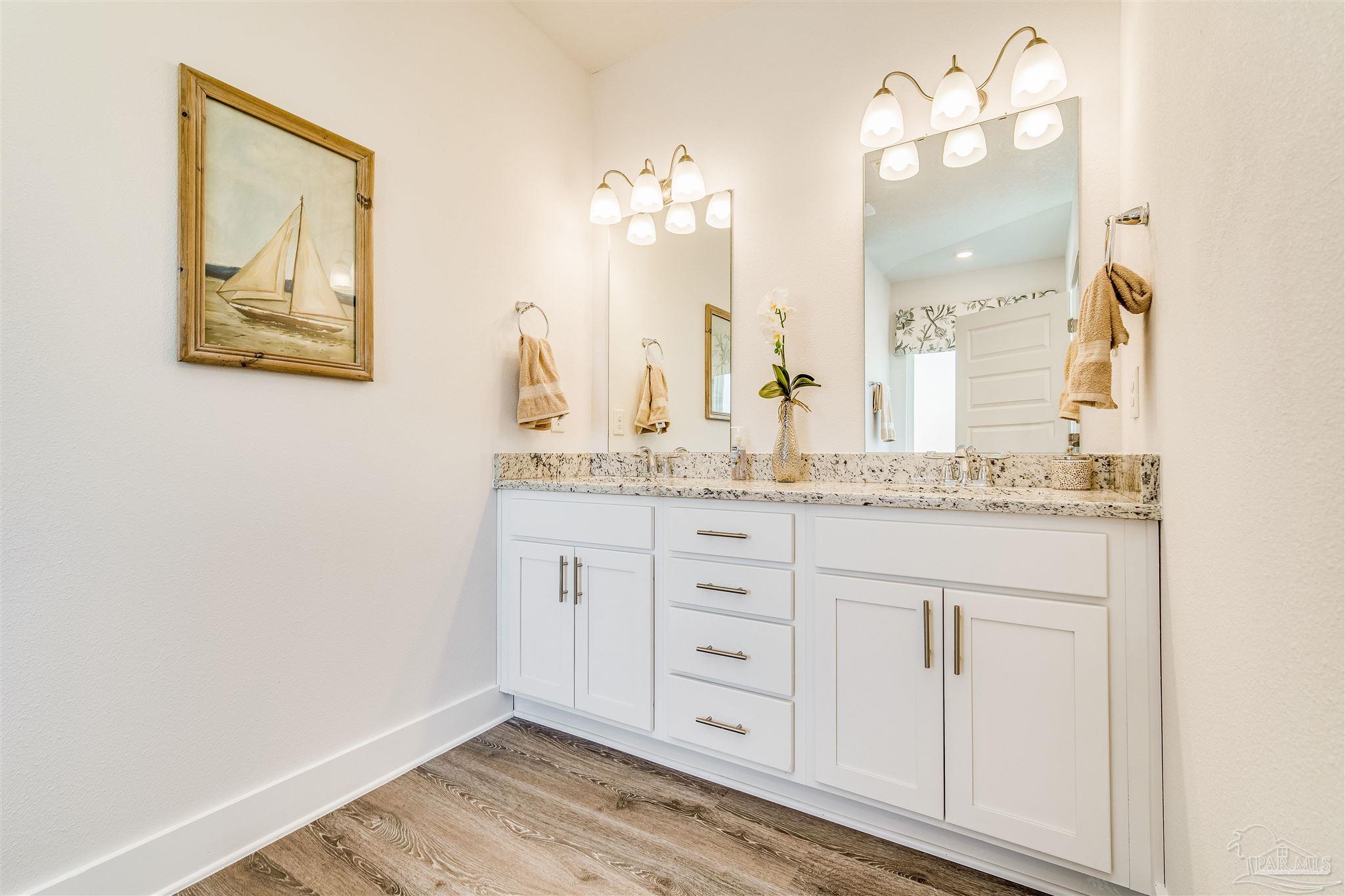 5780 Windham Road Milton, FL 32570 - Photo 27 of 37 a bathroom with a granite countertop sink and a mirror