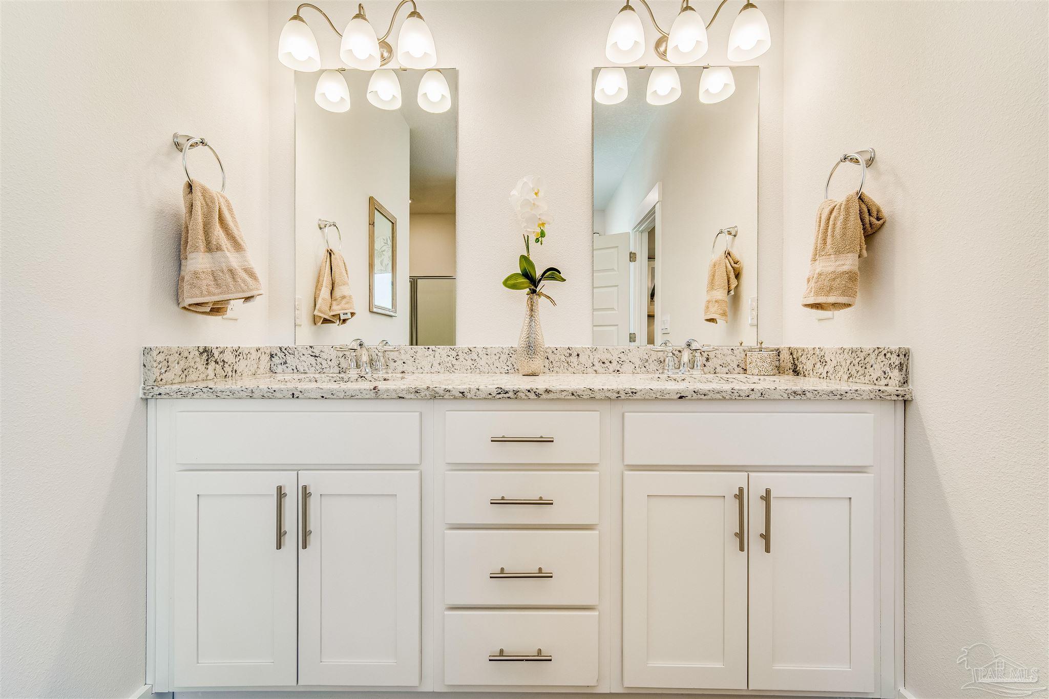 5780 Windham Road Milton, FL 32570 - Photo 28 of 37 a bathroom with a granite countertop sink vanity and mirror