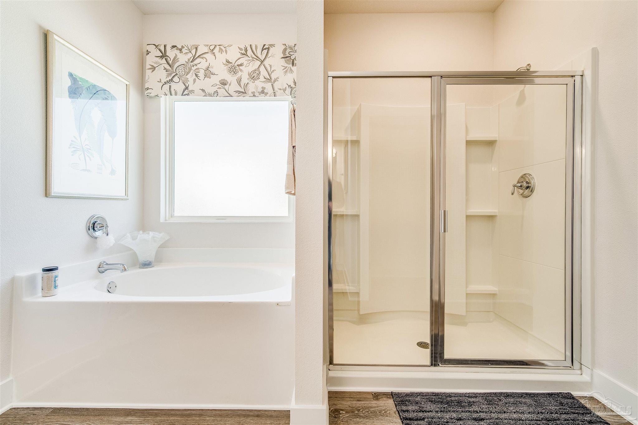 5780 Windham Road Milton, FL 32570 - Photo 29 of 37 a bathroom with a bathtub and a shower