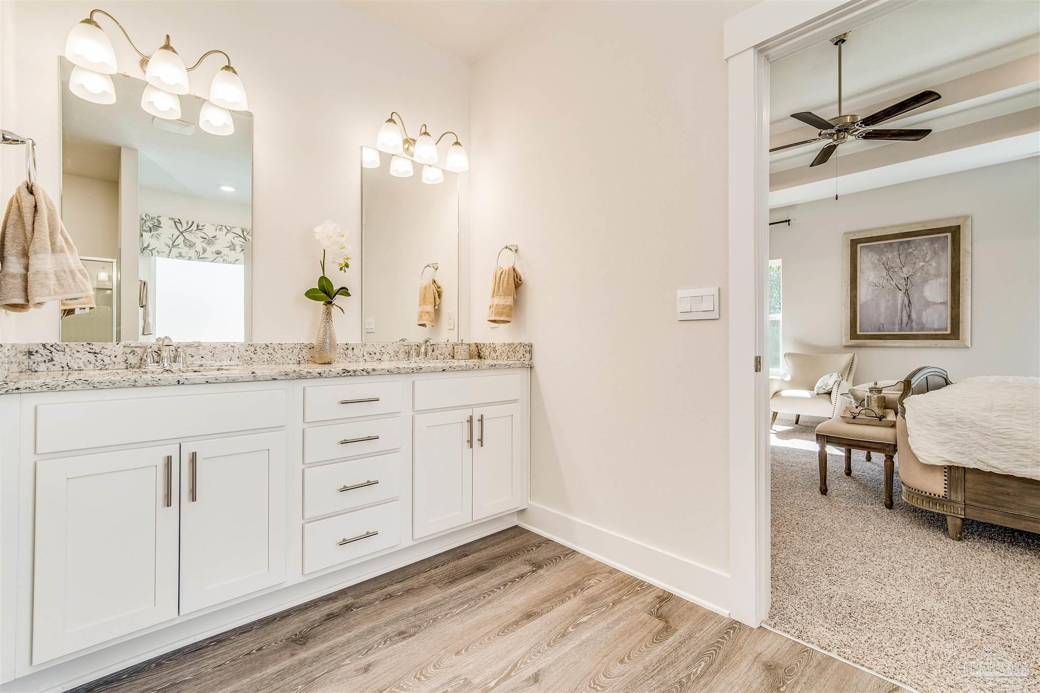 5780 Windham Road Milton, FL 32570 - Photo 30 of 37 a spacious bathroom with a granite countertop sink mirror and vanity