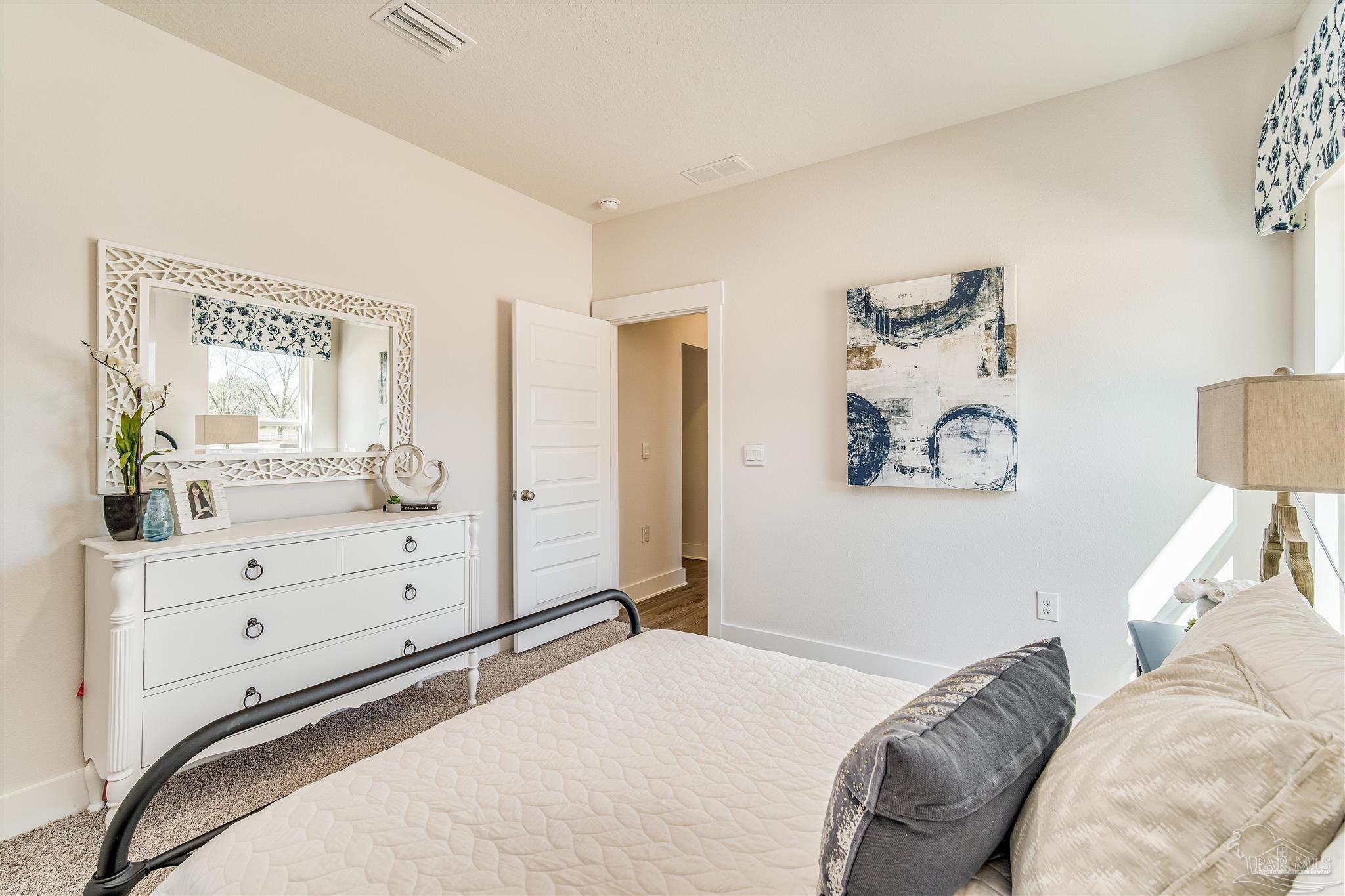 5780 Windham Road Milton, FL 32570 - Photo 34 of 37 a bedroom with a bed and a dresser