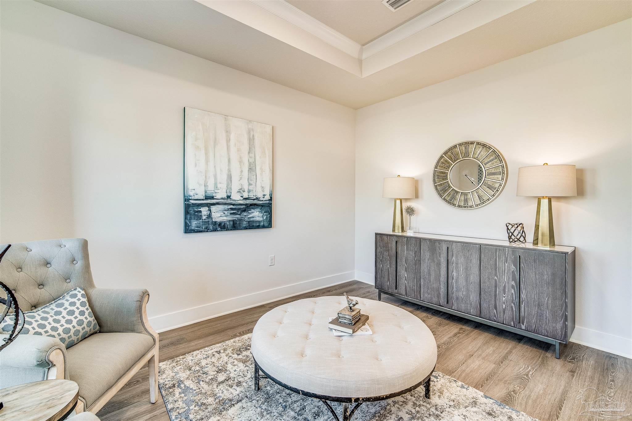 5780 Windham Road Milton, FL 32570 - Photo 9 of 37 a living room with furniture a clock and a window