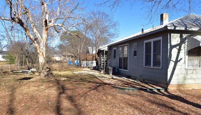 a view of a house with snow on the road