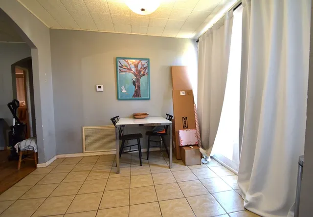 a view of dining room with furniture and a window