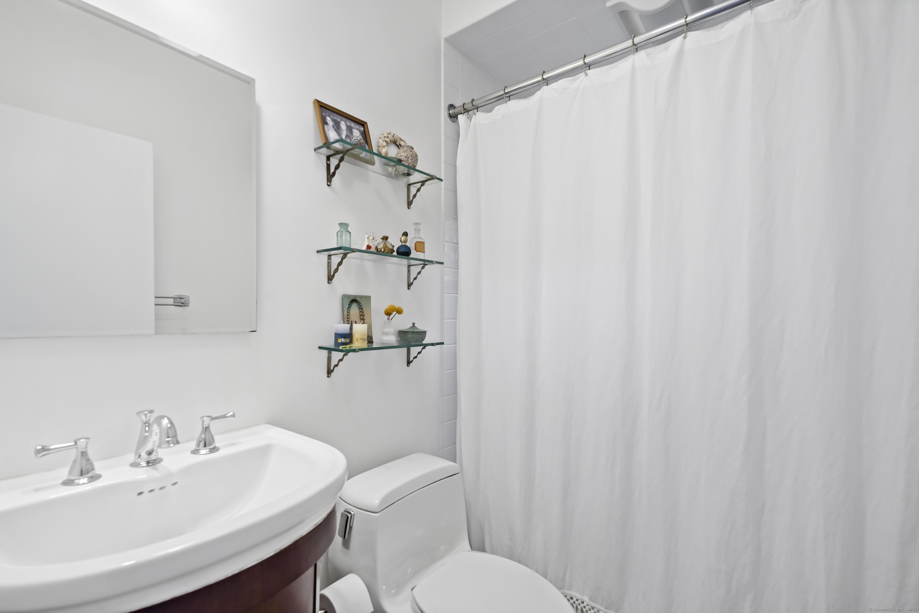 64 Ocean Drive East Stamford, CT 06902 - Photo 15 of 38 a bathroom with a sink mirror and toilet