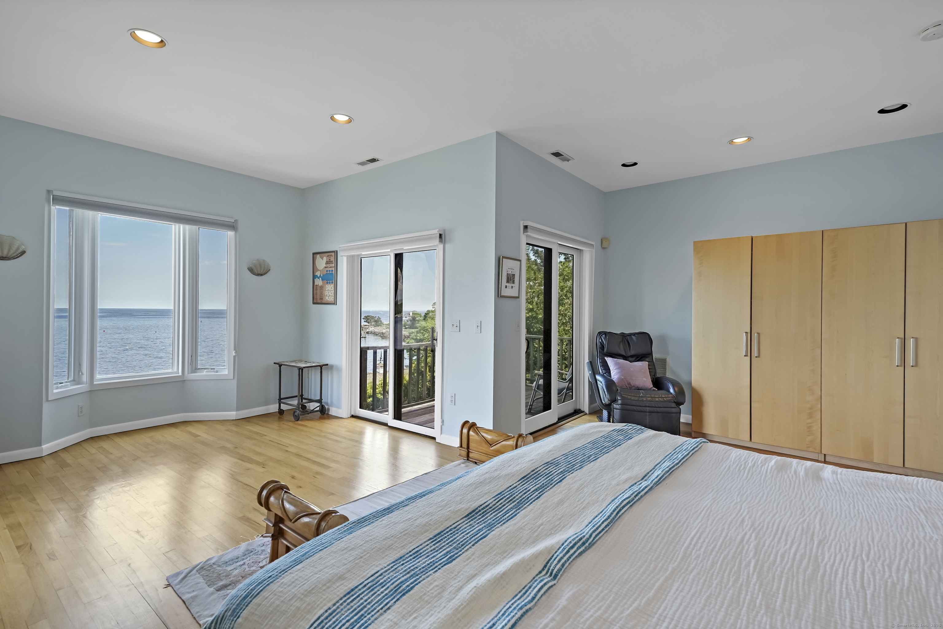 64 Ocean Drive East Stamford, CT 06902 - Photo 17 of 38 a bed room with a bed and large windows