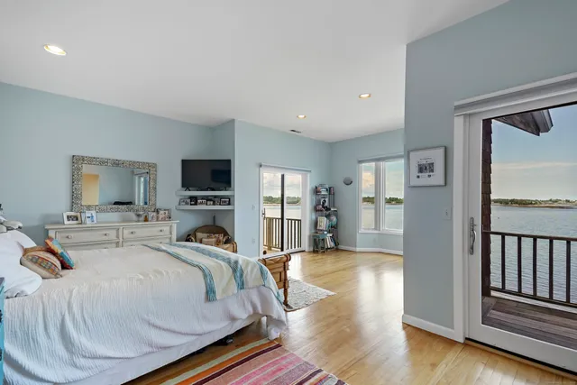 a view of a balcony with wooden floor and fence