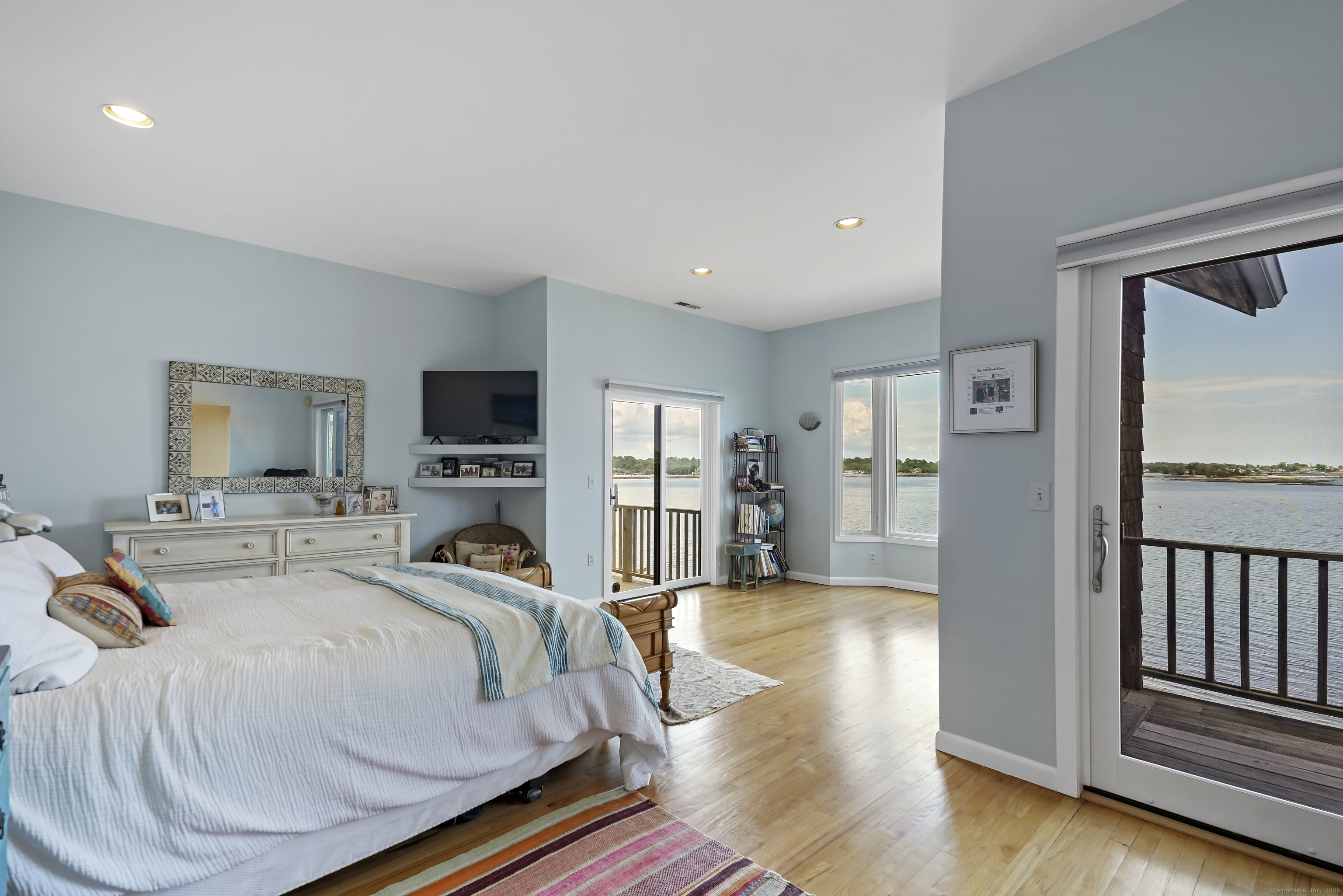 64 Ocean Drive East Stamford, CT 06902 - Photo 18 of 38 a bedroom with a bed and wooden floor