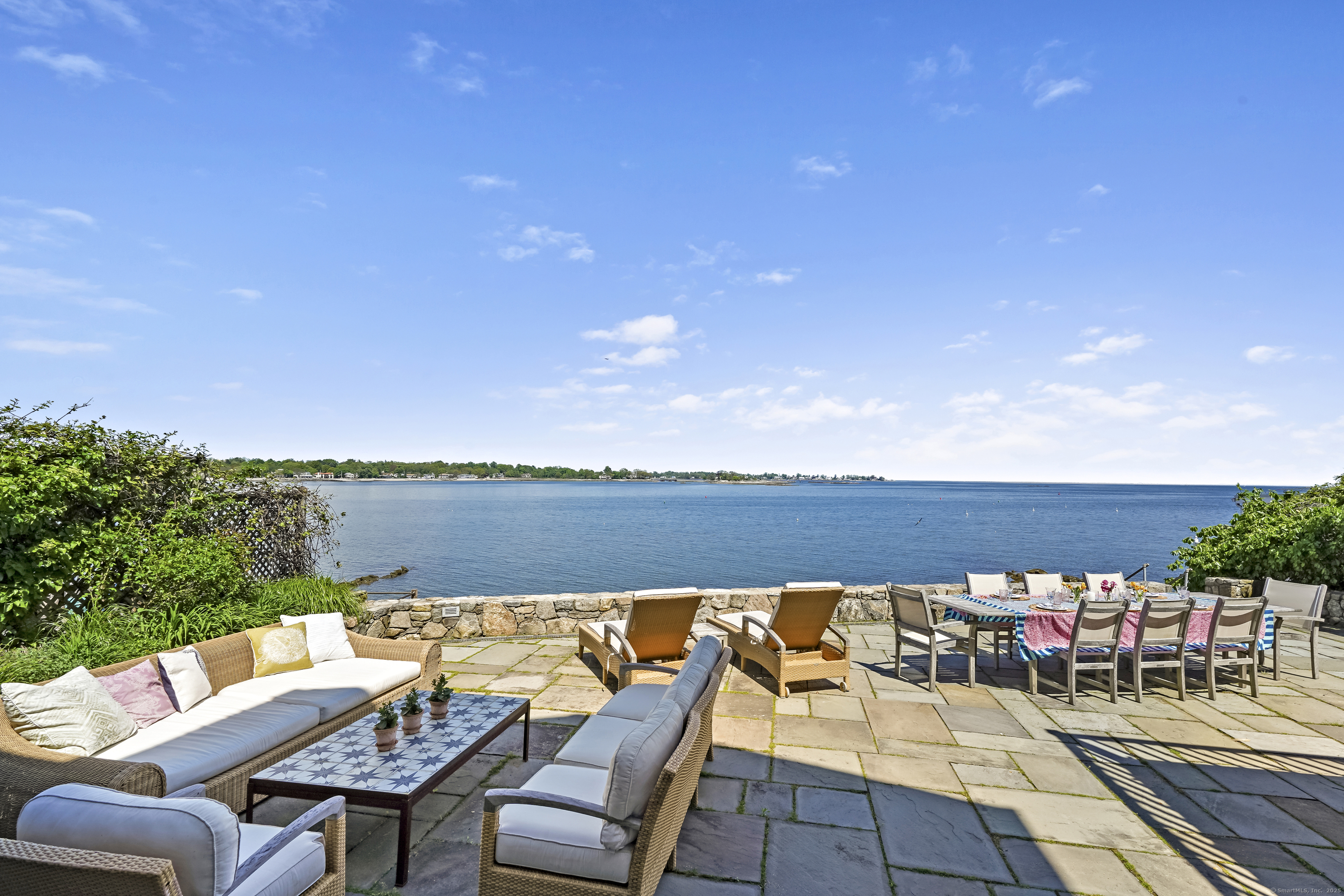 64 Ocean Drive East Stamford, CT 06902 - Photo 2 of 38 a view of a chairs and table on the terrace