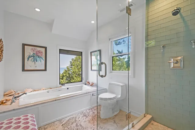 a bathroom with a tub and a window