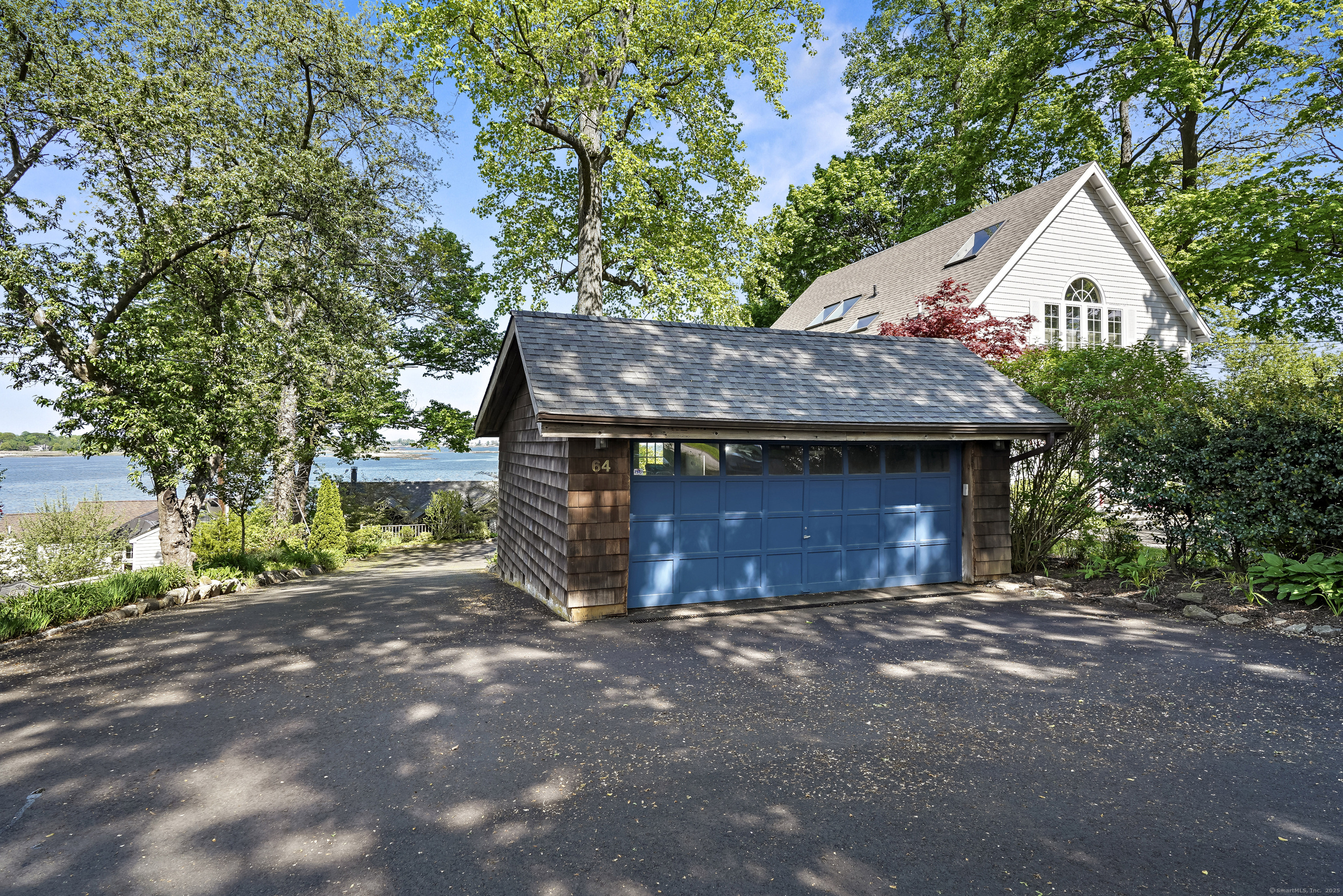 64 Ocean Drive East Stamford, CT 06902 - Photo 35 of 38 a view of a house with a yard and garage