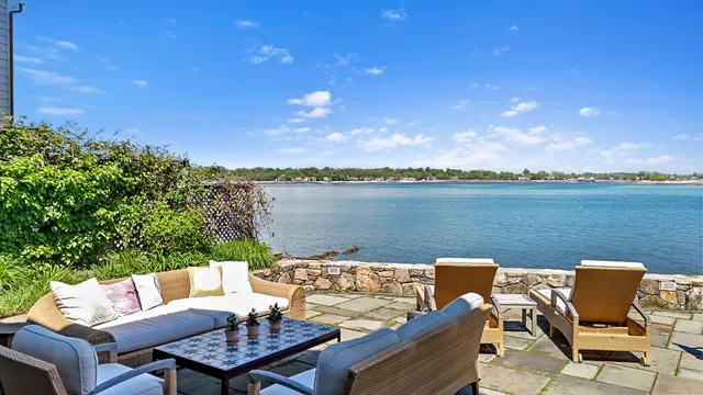 a view of a terrace with furniture and a lake view