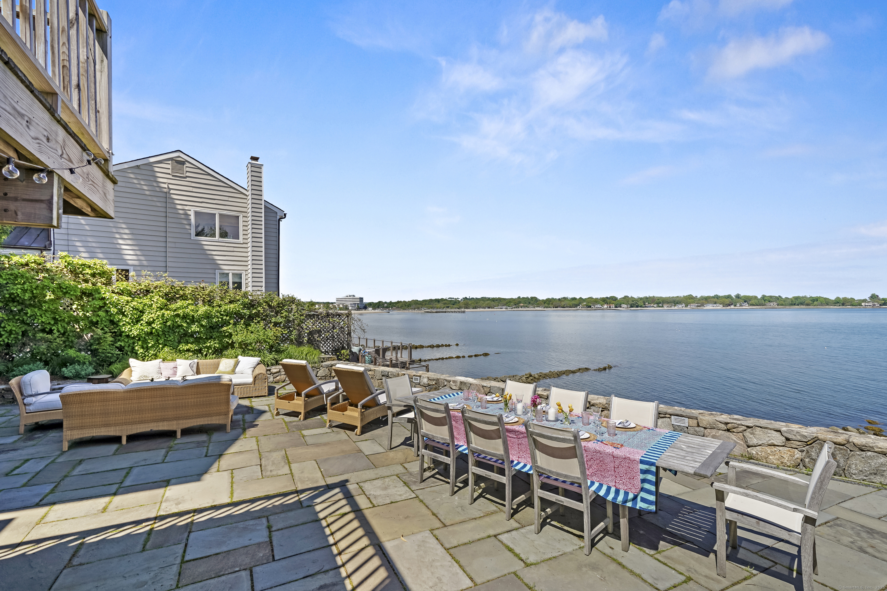 64 Ocean Drive East Stamford, CT 06902 - Photo 5 of 38 a view of a terrace with furniture and a lake view