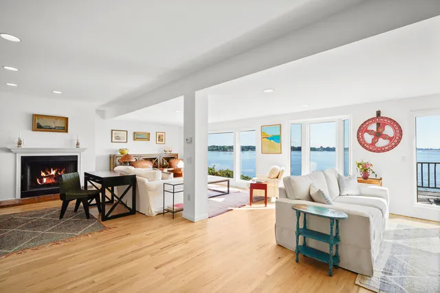 a living room with furniture a table and kitchen view