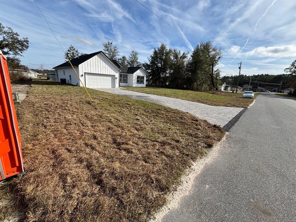 7518 Southwest 128th Street Ocala, FL 34473 - Photo 2 of 5 a view of a house with a yard