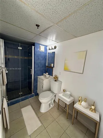 a bathroom with a toilet sink a shower and mirror