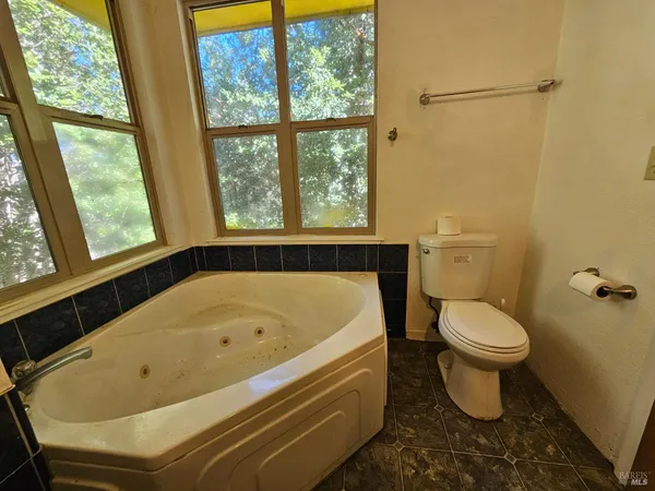 a white bath tub sitting next to a toilet