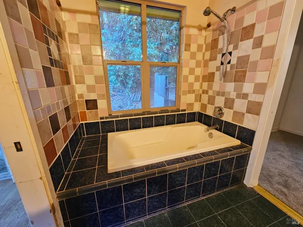 a bathroom with a bathtub and shower