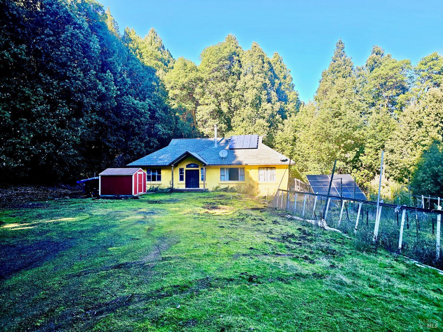 27651 Skyview Road Willits, CA 95490 - Photo 2 of 18 a front view of a house with yard and green space