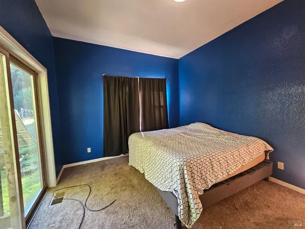a bed sitting in a bedroom next to a window