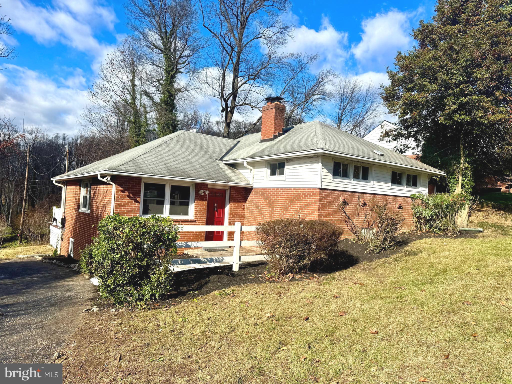 1204 St Andrews Way Baltimore, MD 21239 - Photo 2 of 15 a front view of a house with a yard