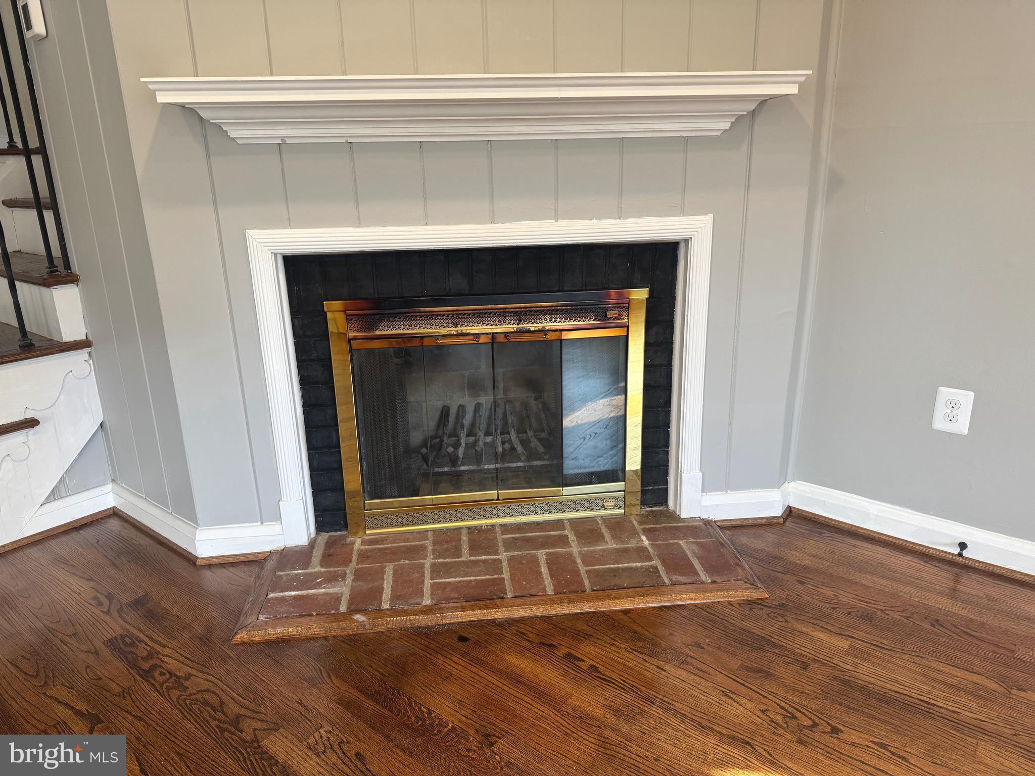 1204 St Andrews Way Baltimore, MD 21239 - Photo 5 of 15 a view of an empty room with wooden floor and a fireplace