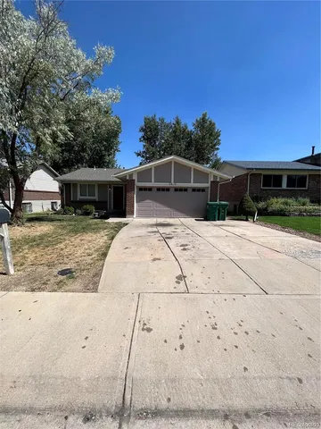 a view of a house with wooden fence