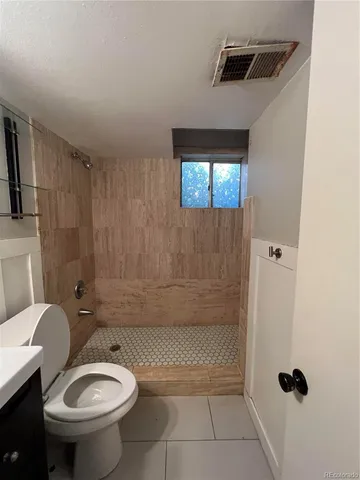 a bathroom with a toilet a sink and bathtub