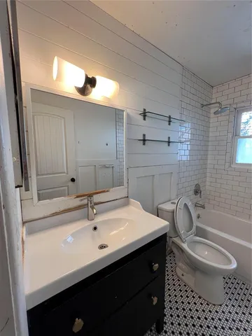 a bathroom with a sink a toilet and a bathtub