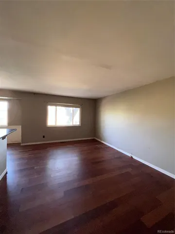 a view of wooden floor and windows in a room