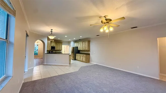 a kitchen with stainless steel appliances kitchen island granite countertop a refrigerator and a stove top oven