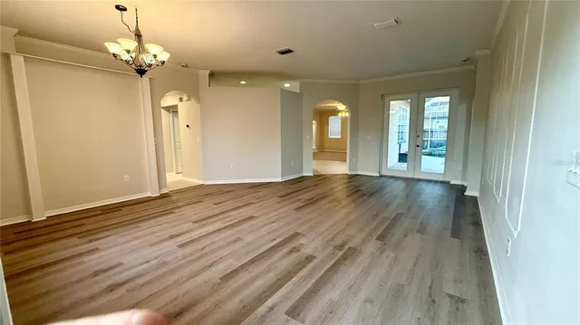 a view of livingroom with hallway and wooden floor