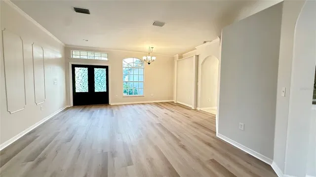 wooden floor in an empty room with a window
