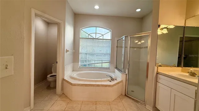 a bathroom with a tub a toilet and a sink