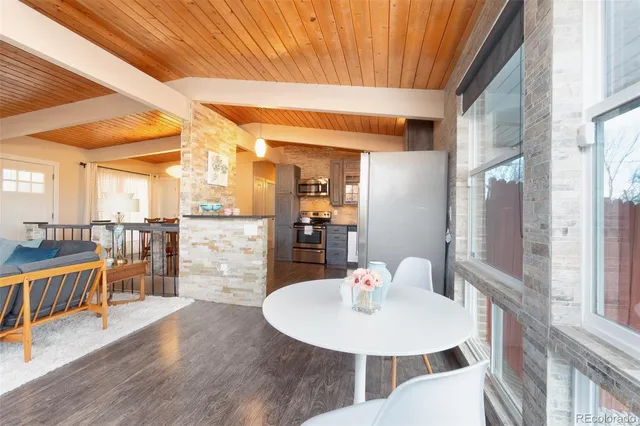 a view of a dining room with furniture a chandelier and wooden floor
