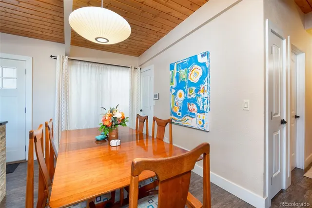 a dining room with furniture and wooden floor