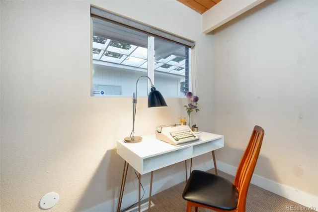 a workspace with furniture and window