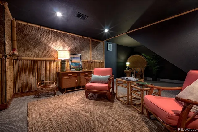 a dining room with furniture and a flat screen tv