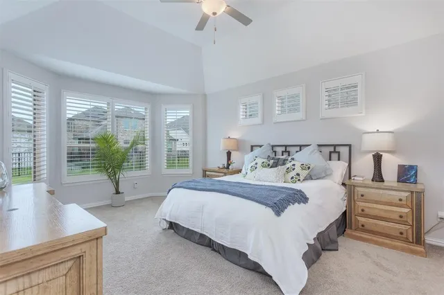 a bedroom with a bed and a night stand