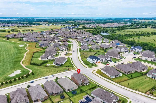an aerial view of residential houses with outdoor space and river