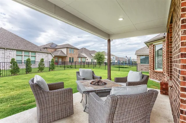 a view of a house with a backyard porch and sitting area