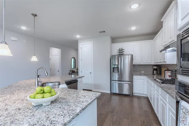 a kitchen with counter top space appliances and cabinets
