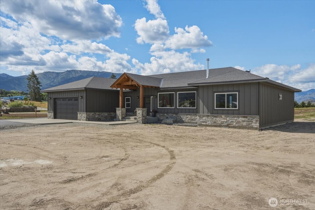 110 Slide View Lane Manson, WA 98831 - Photo 34 of 38 a front view of a house with a yard and garage