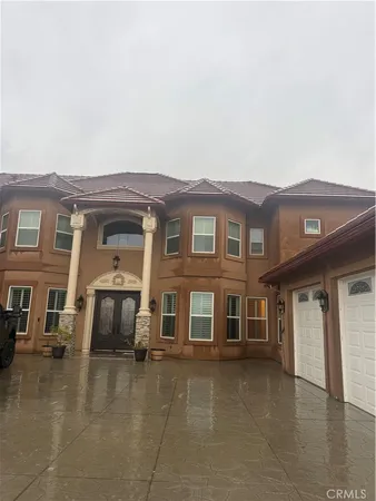 a front view of a residential apartment building with a yard